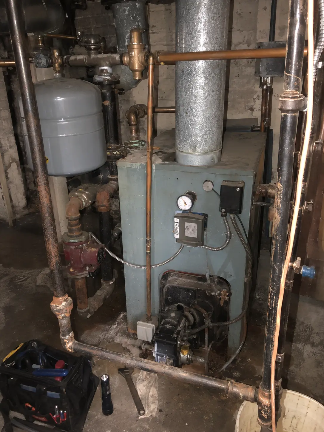 Boiler and copper heating piping in a New York City basement